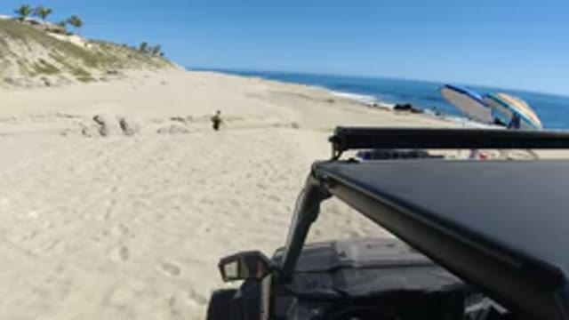 LOS CABOS MEXICO-2019: Vehicle Parked at Seashore with People Enjoying Beach