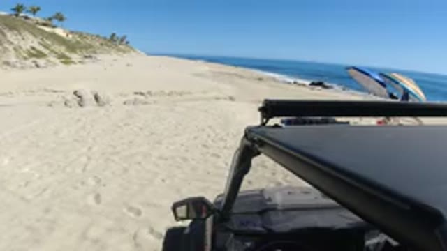 LOS CABOS MEXICO-2019: Car Stopped On The Sea Sand For People To Enjoy A Sunny Day