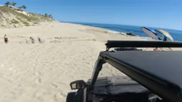 LOS CABOS MEXICO-2019: Black Car Parking On Beach Sand Sunny Weather Idle