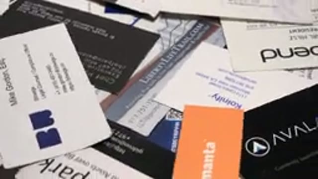 A Turn Table Full Of Different Business Cards Of Different Colors And Lettering