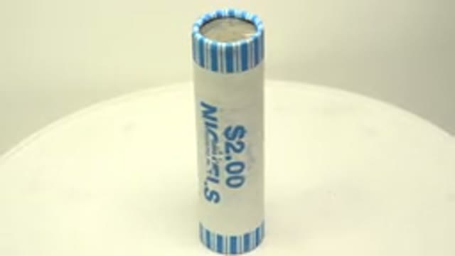 Video Of A Roll Of Nickels Being Displayed Slowly Turning On A White Turntable