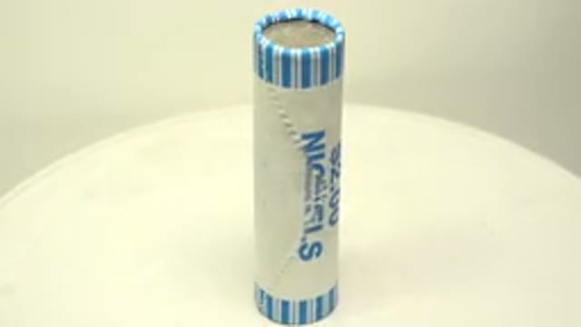 Pack Of Nickels Rotating On A White Surface
