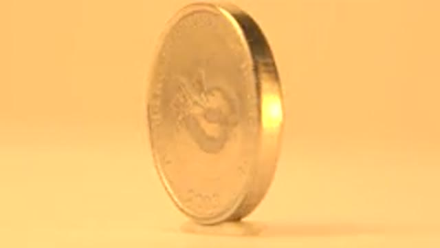 2014: Golden Piece Of Money With Word Writes In That Is Turning Around
