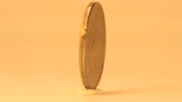 Small Golden Coin Rotates Endlessly