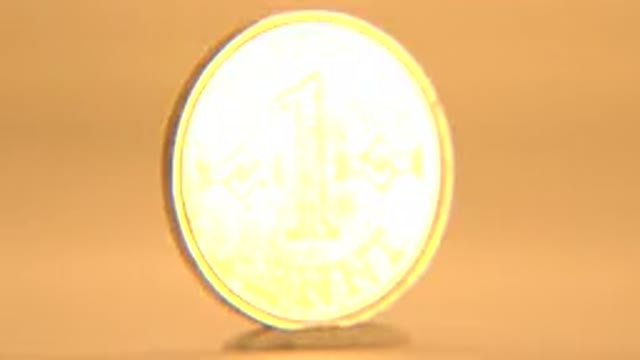 A Spinning Golden Coin With Engravings On It