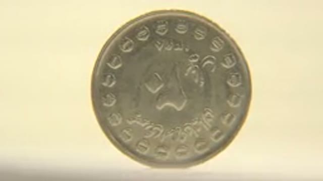 Spinning Engraved Silver Coin On Display