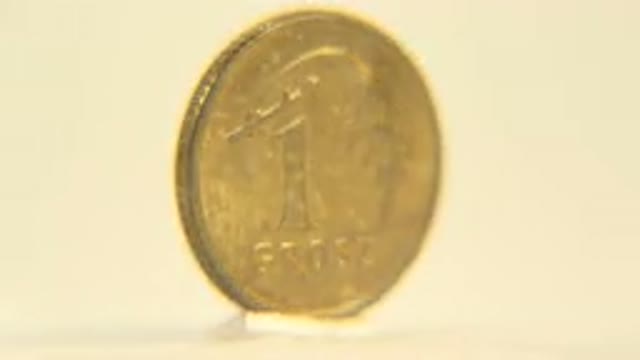 A View Of A Gold Coin Rotating Slowly With One Side Marked With And The Other
