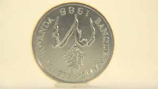 UN Franc Coin Rotating On A Flat Surface