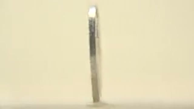 Spinning Silver Coin With Text On It Close Up Blank Background