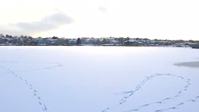 HIDDEN LAKE COLORADO-2014: Drone Footage Over Snow Covered Lake With Tracks
