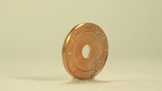 A Golden Coin With A Hole In The Middle Keeps Rotating