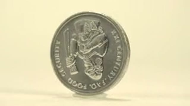 Rotating Silver Coin On A Flat Surface