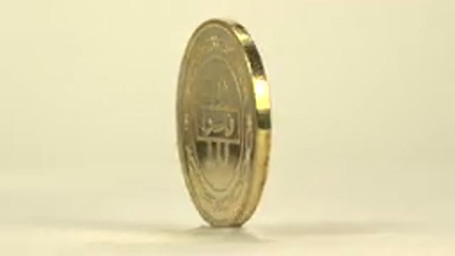 A Rotating Golden Coin Decorated With Coconut Trees And Is From The State Of