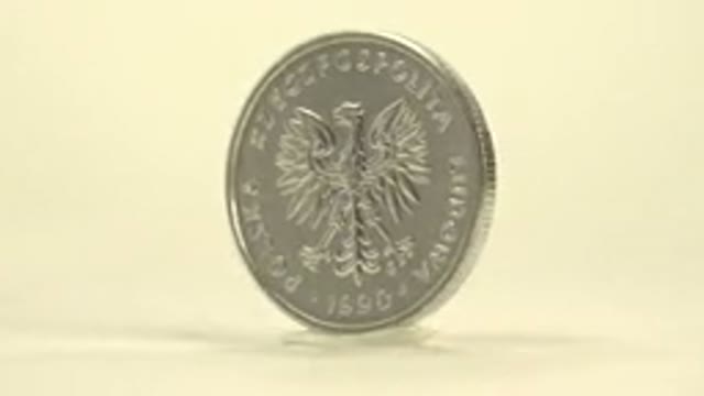 Spinning Shiny Silver Coin On Display