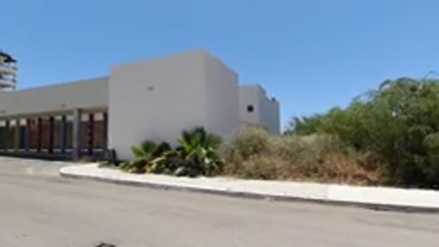 SAN JOSE DEL CABO MEXICO-2020: A Modern Grey Building Near Green Plants