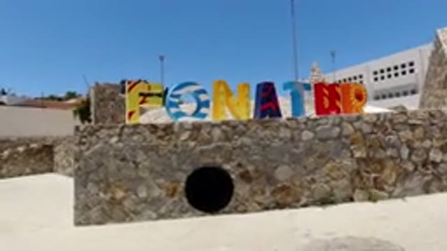 SAN JOSE DEL CABO MEXICO-2020: Colorful Sign On Stone Wall With A Building In