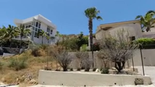 SAN JOSE DEL CABO MEXICO-2020: A Person Filming Two Villas On The Road Side With