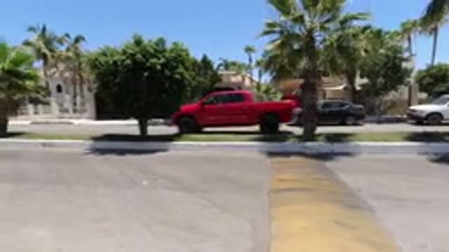 SAN JOSE DEL CABO MEXICO-2020: A Big Red Pickup Truck Is Driving Through A Nice Neighborhood