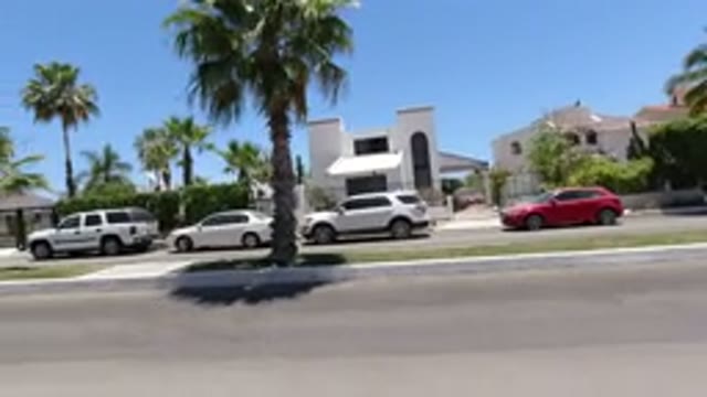 SAN JOSE DEL CABO MEXICO-2020: Camera Pans From Right To Left Down Divided Street