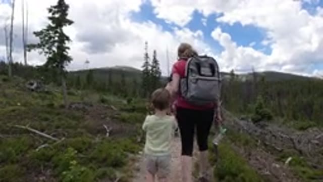 WINTER PARK COLORADO-2019: Boy and Two Women Hiking Along a Trail with Fluffy Clouds