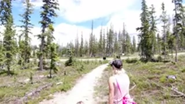 WINTER PARK COLORADO-2019: A Woman And Girl Walk Down A Forested Dirt Trail