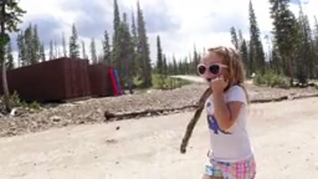 WINTER PARK COLORADO-2019: Child Girl Walking On A Dirt Road With Lots Of Trees