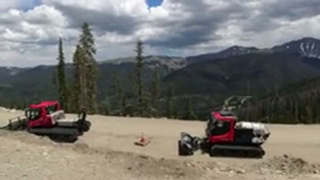 WINTER PARK COLORADO-2019: A Group Of Bulldozers Parked By The Side Of The