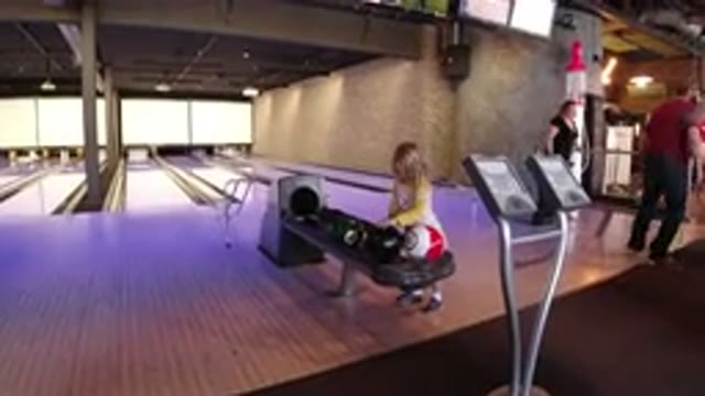 WINTER PARK COLORADO-2019: Little Girl Playing At Bowling Station While Her