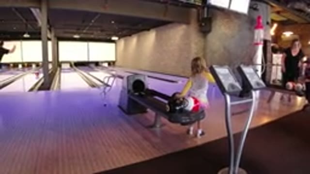 WINTER PARK COLORADO-2019: Child Playing With Bowling Ball On Bowling Alley