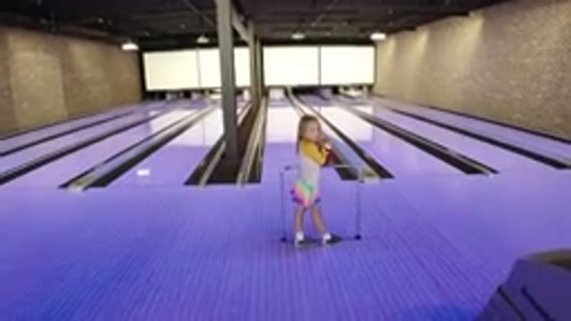 WINTER PARK COLORADO-2019: A Child At A Bowling Alley Throws A Red Ball Down The Lane