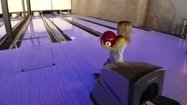 WINTER PARK COLORADO-2019: Blonde Girl Throwing Red Ball at Bowling Alley