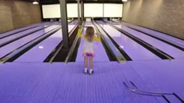 WINTER PARK COLORADO-2019: Small Child Throwing A Bowling Ball Down A Lane