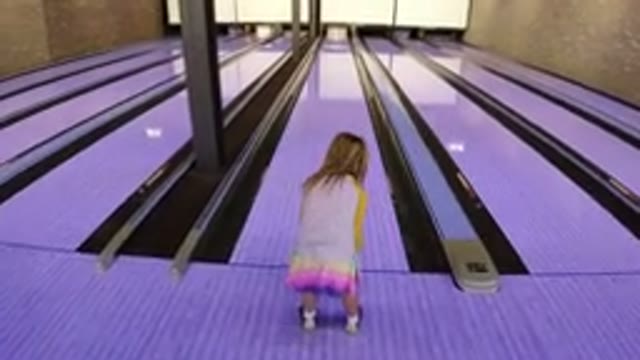 WINTER PARK COLORADO-2019: A Small Girl Playing Bowling On The Floor