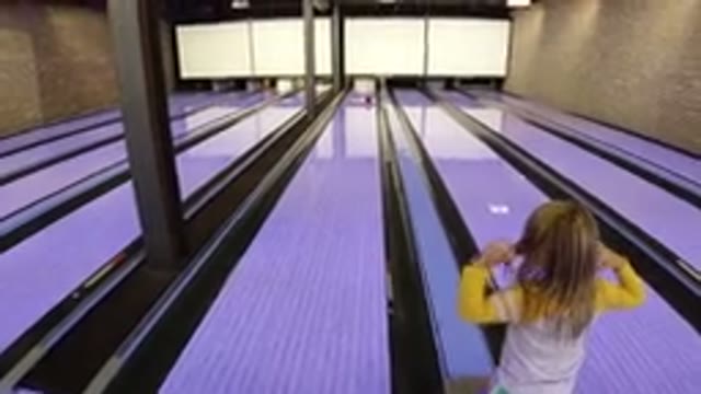 WINTER PARK COLORADO-2019: A Girl Playing Bowling On The Mall Floor