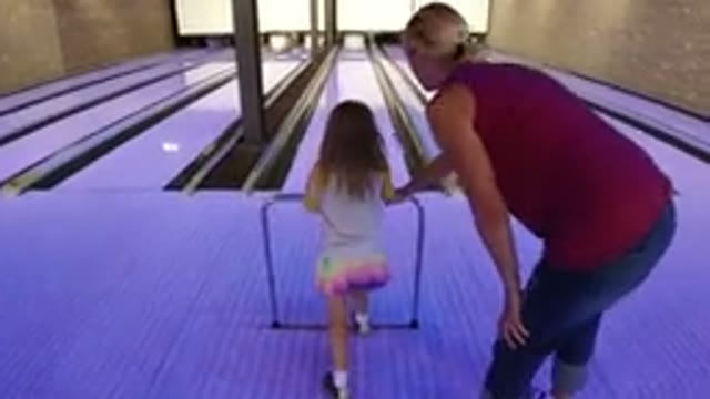 WINTER PARK COLORADO-2019: An Adult Teaching A Kid How To Roll A Bowling Ball