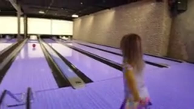 WINTER PARK COLORADO-2019: A Little Girl Playing On A Bowling Alley