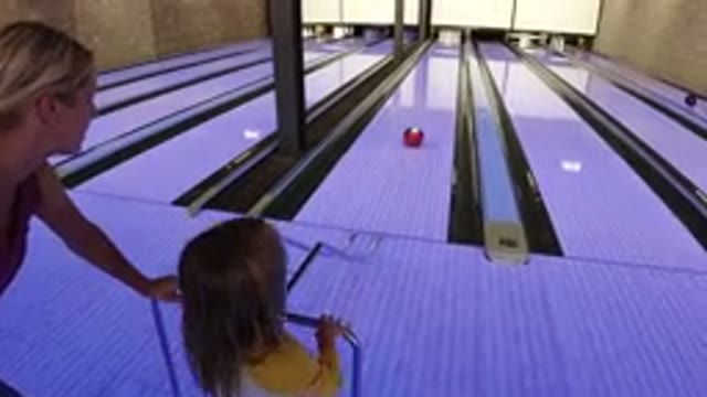 WINTER PARK COLORADO-2019: Little Girl Plays Bowling With Her Mother And Is