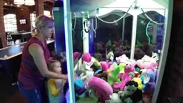 WINTER PARK COLORADO-2019: Mom And Daughter Play Arcade Game Together For