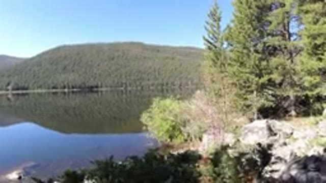 WINTER PARK COLORADO-2019: Snow-Covered Lake View With Trees And Rocks