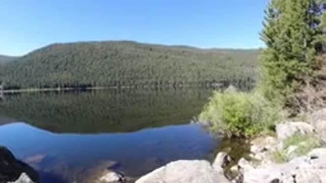 WINTER PARK COLORADO-2019: Clear Lake On Sunny Day Under Blue Sky With Dark