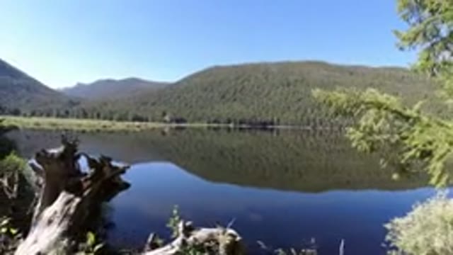 WINTER PARK COLORADO-2019: A View Of A Large Lake With Mountains And Trees In