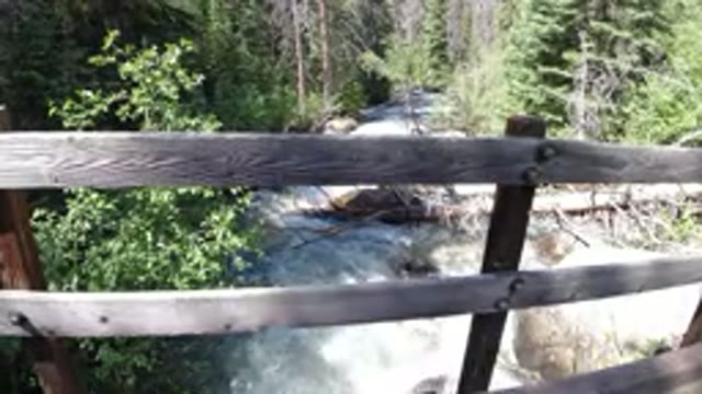 WINTER PARK COLORADO-2019: A Running Stream Seen From A Foot Bridge In The