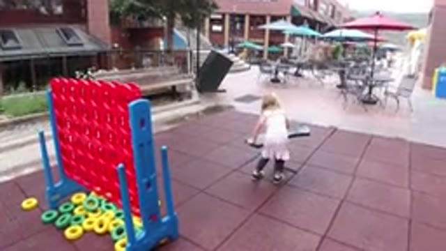 WINTER PARK COLORADO-2019: Young Girl Approaches and Sits on Play Equipment