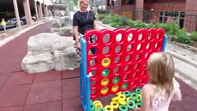 WINTER PARK COLORADO-2019: An Adult And A Kid Playing Connect Four On A Big
