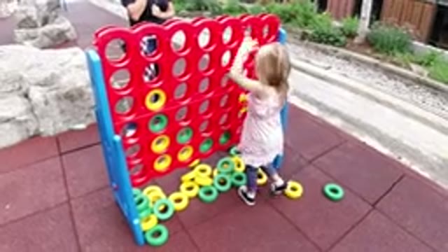 WINTER PARK COLORADO-2019: Little Girl Playing a Giant Tic Tac Toe Game Outside