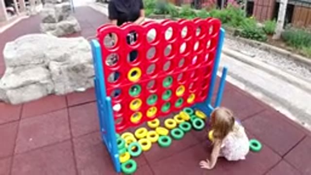 WINTER PARK COLORADO-2019: Girl Mounting Yellow and Green Blocks on Red Wall