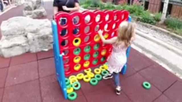 WINTER PARK COLORADO-2019: Little Girl Playing in the City While Her Mother Watches