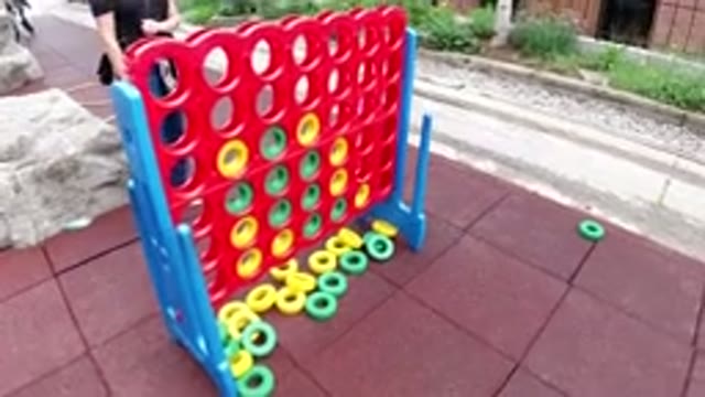 WINTER PARK COLORADO-2019: Girl Plays Life-size Connect Four Game Outside