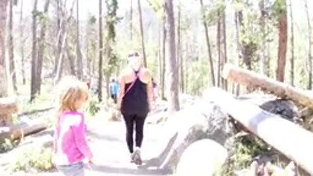 WINTER PARK COLORADO-2019: Girl in Pink Hiking with Mother Carrying Black Purse
