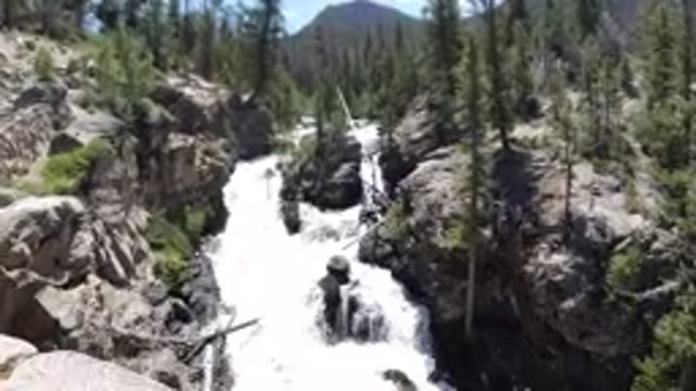 WINTER PARK COLORADO-2019: Panning Camera Shot Of Water Rapids Between Two Cliffs